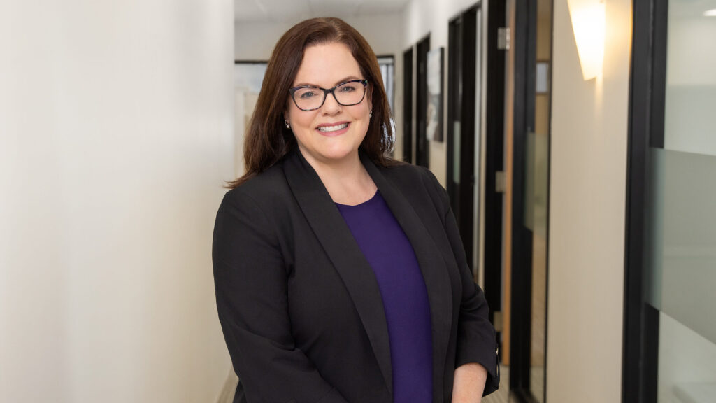 A photo of new NSBS Interim Executive Director Jennifer Pink standing in a hallway at the NSBS offices.